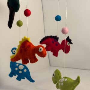 Felt dinosaur baby mobile on a blue wool-wrapped ring